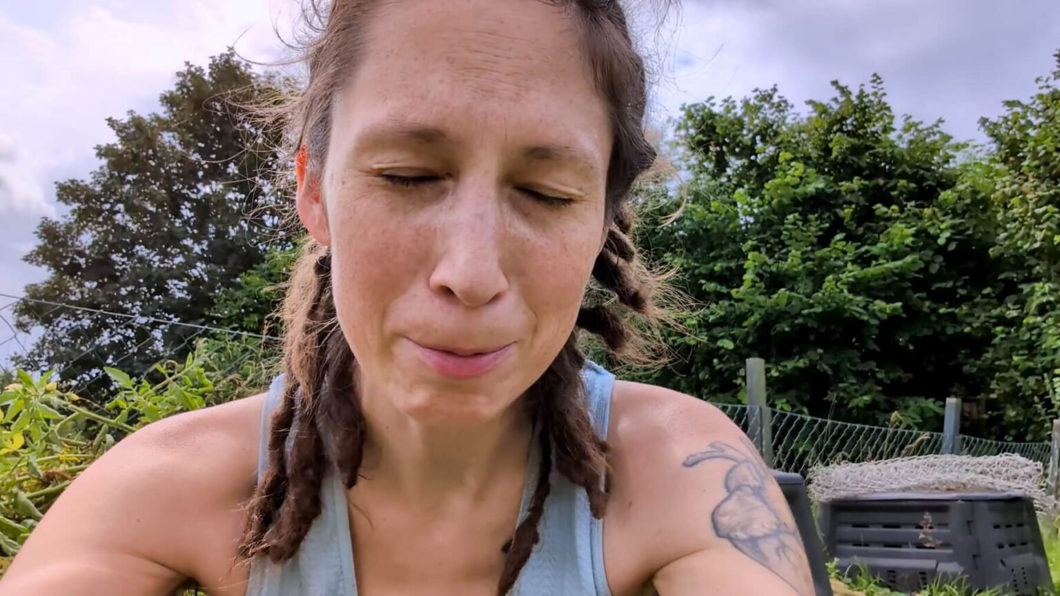 A portrait of Kate. She is crying while trying to talk. Her eyes are closed.