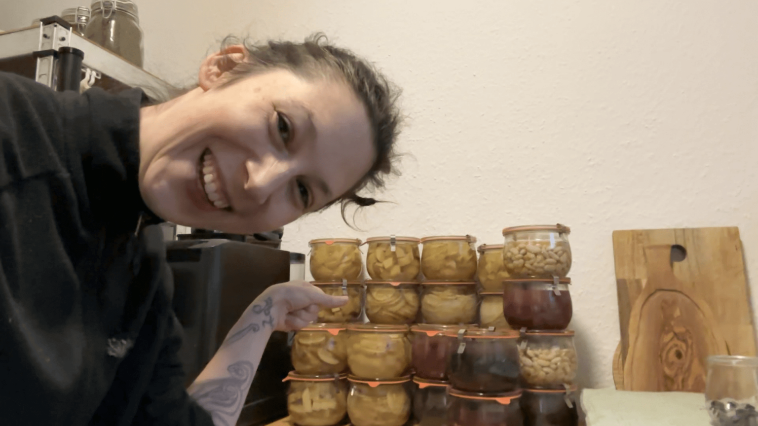 Kate points to a stack of canned potatoes. Some of them are sliced, some diced, some in wedges. Some were made from red or purple potatoes.